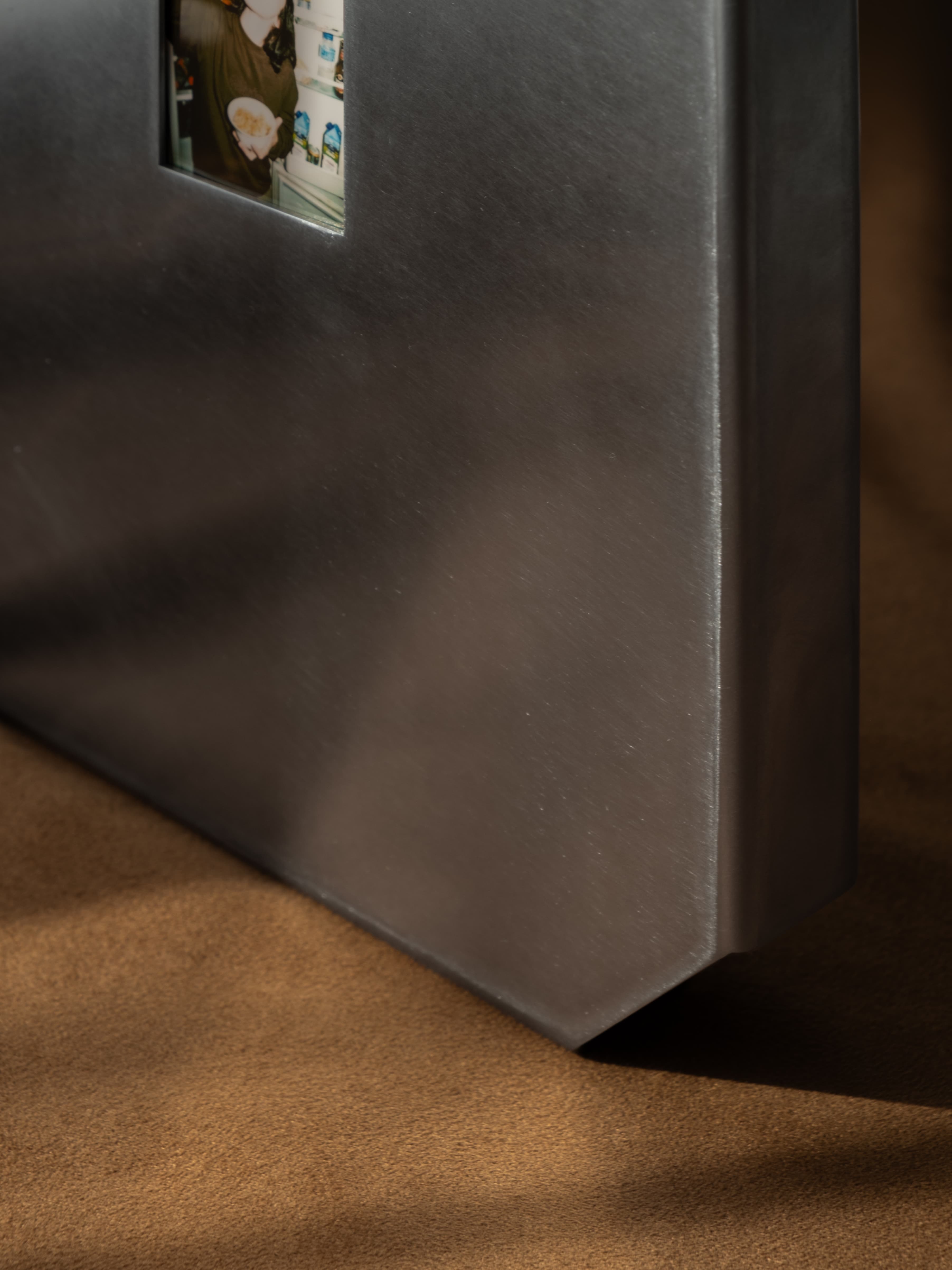 Orbital-finish stainless steel detail of the Oddjoy Memory Frame