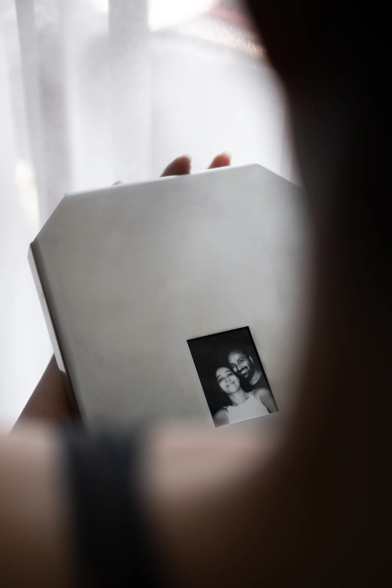Relic 01 held close with a black-and-white photograph